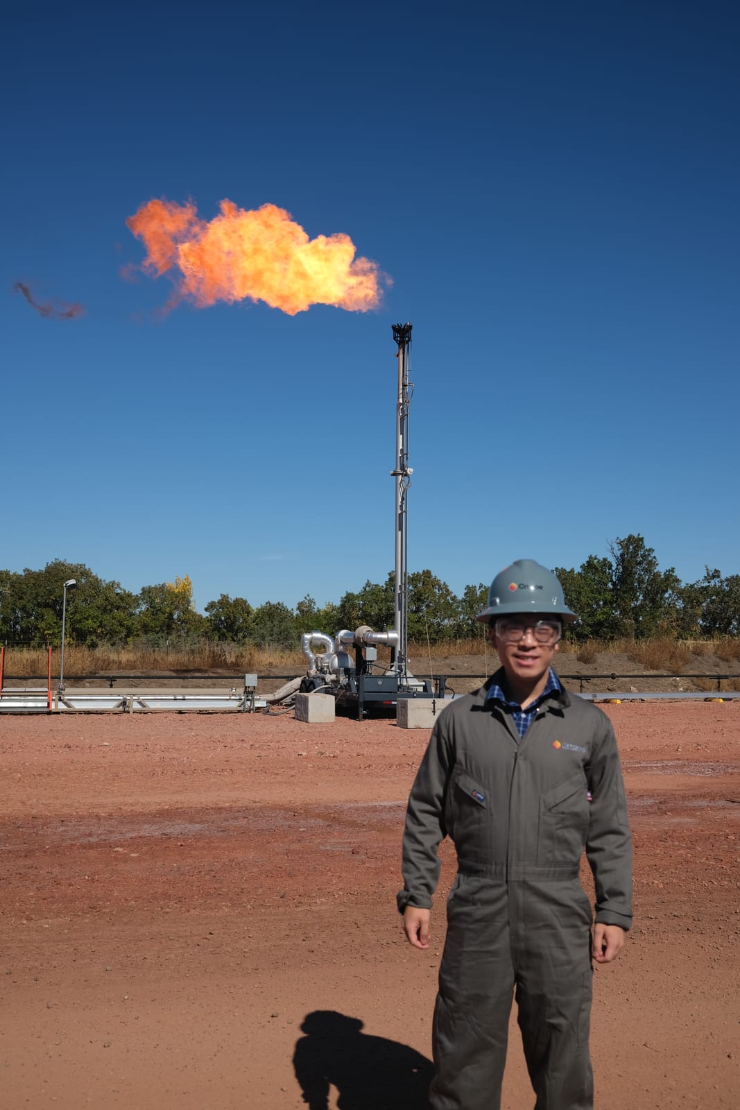My visit to the Williston site, wearing protective gear beside the gas flare
